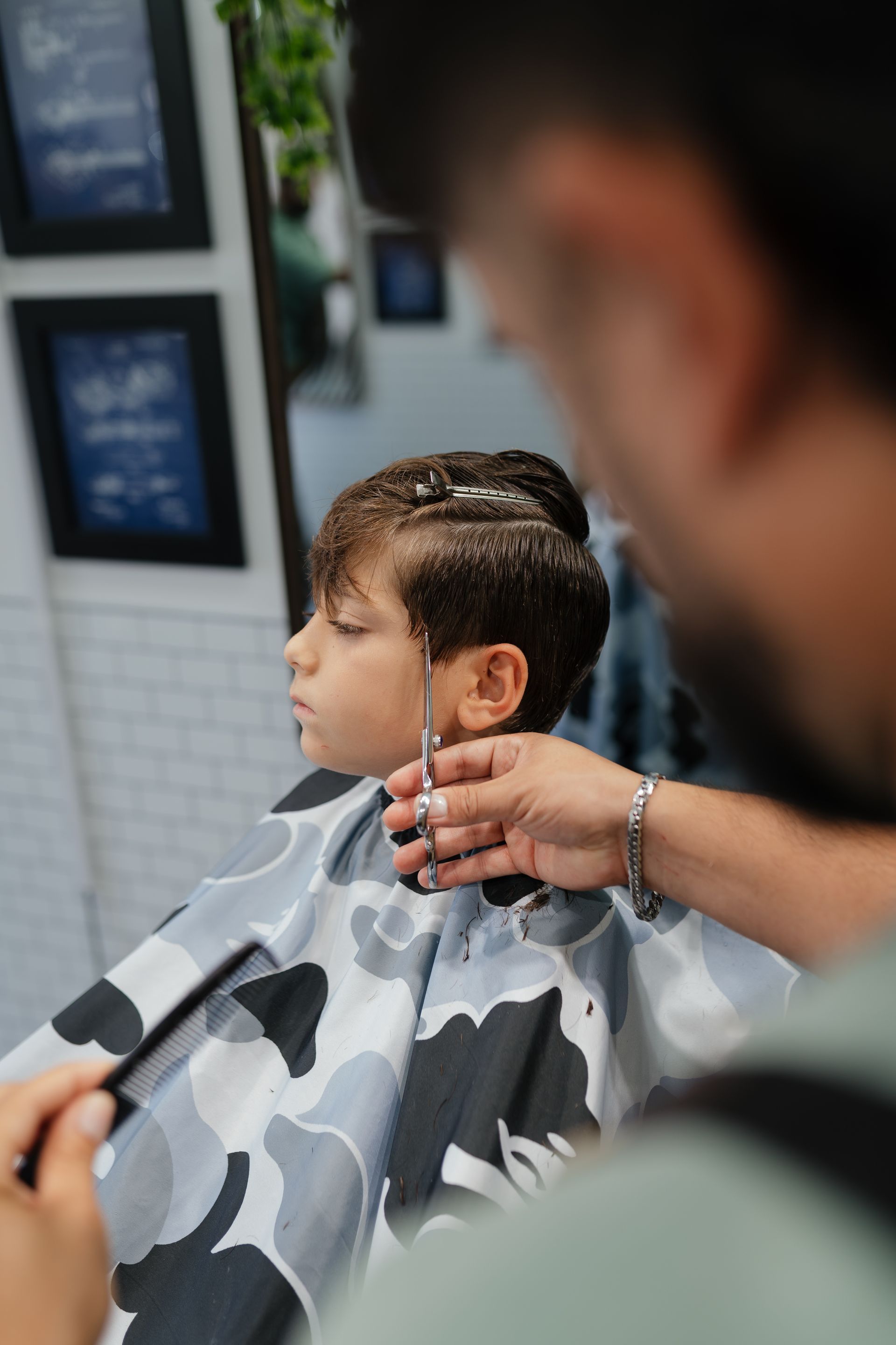 Client getting a precision haircut at Modern Man Barber Studio in Long Branch, NJ, leaving confident