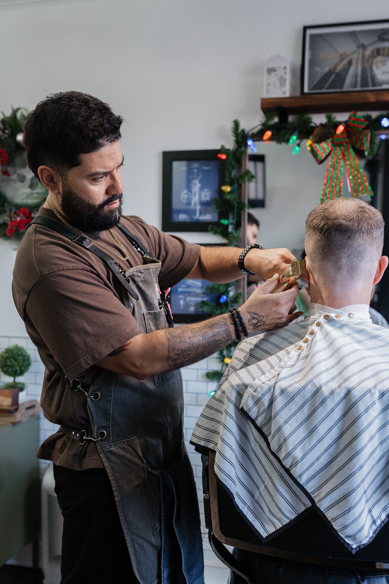 Client consulting with a barber at Modern Man Barber Studio in Long Branch, NJ for a tailored cut.
