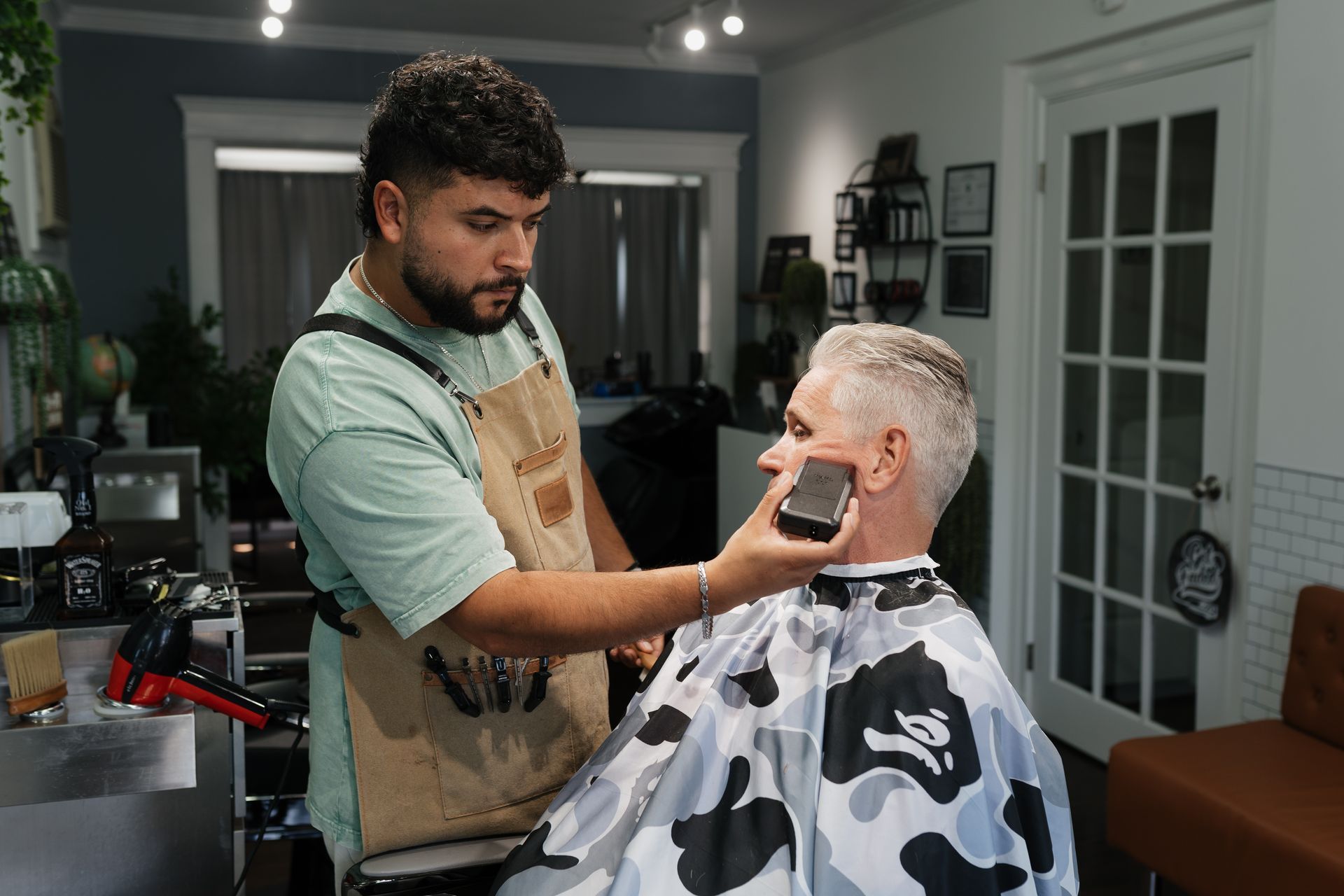 Barber shaping a clean fade at Modern Man Barber Studio in Long Branch, NJ.