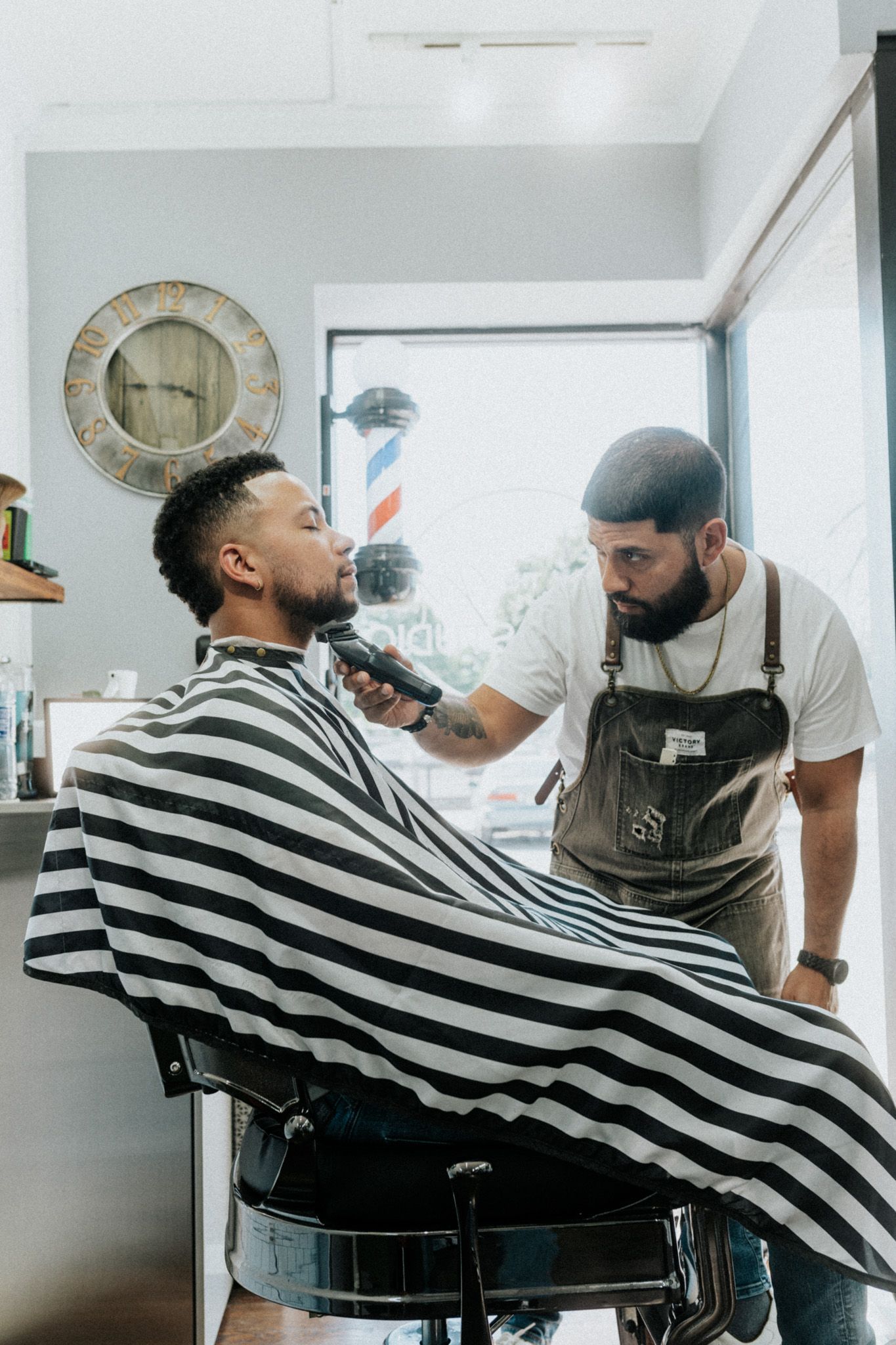 Client maintaining a fresh fade with a brush and lightweight pomade from Modern Man Barber Studio in Long Branch, NJ for a sharp look.