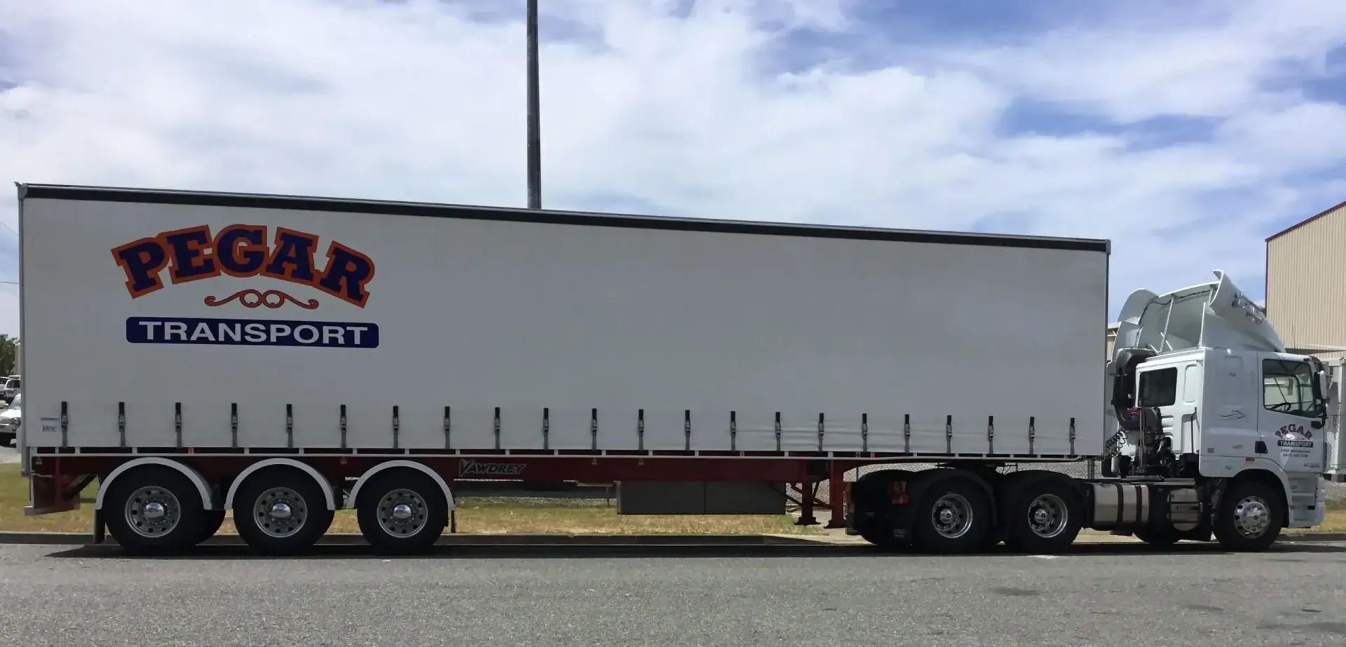 Three White Trucks Are Parked Next To Each Other In A Parking Lot — Pegar Transport In Newcastle, NSW