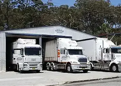 A Man Is Driving A Forklift In A Warehouse — Pegar Transport In Newcastle, NSW