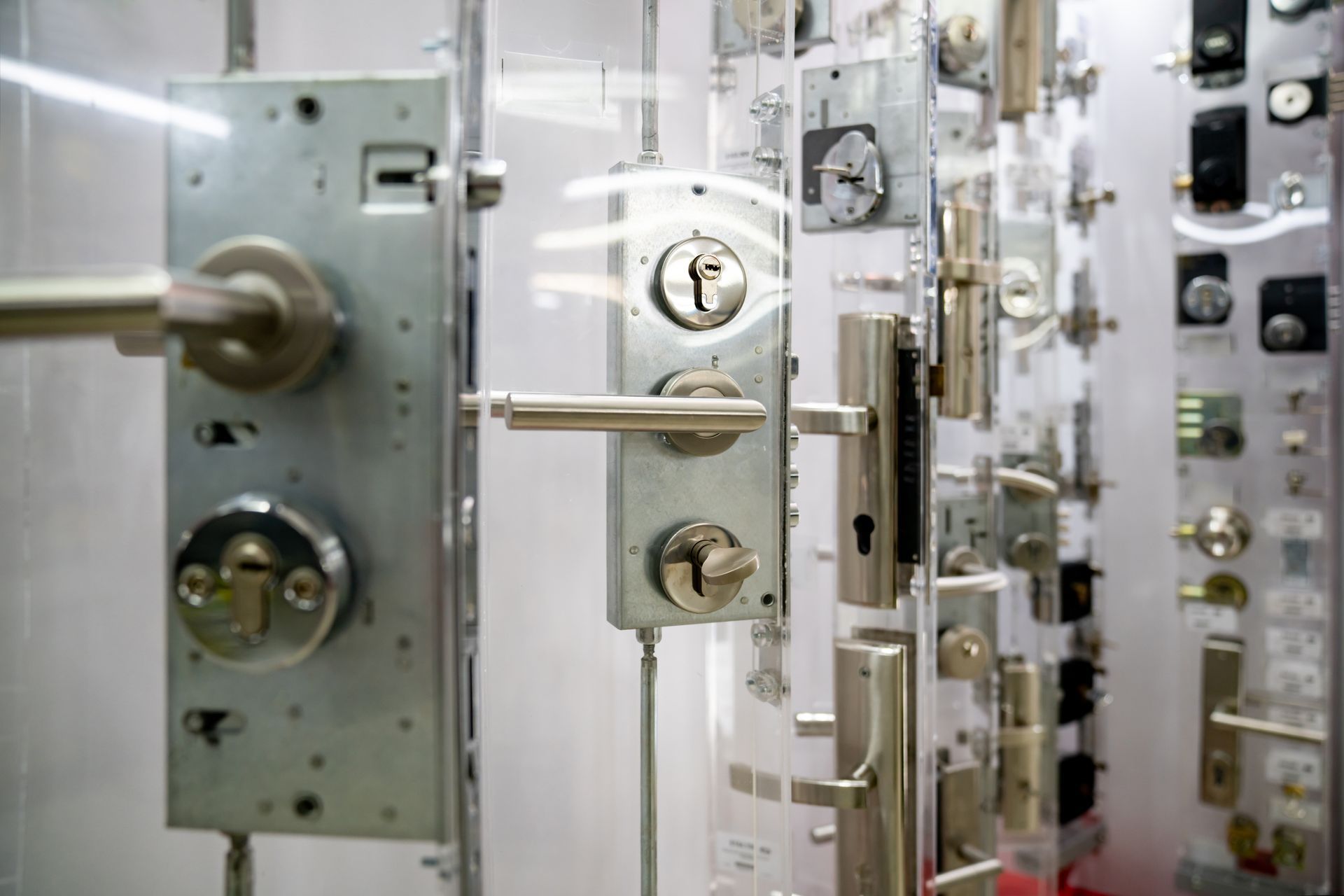 Display of various metal door locks and hardware in a store.