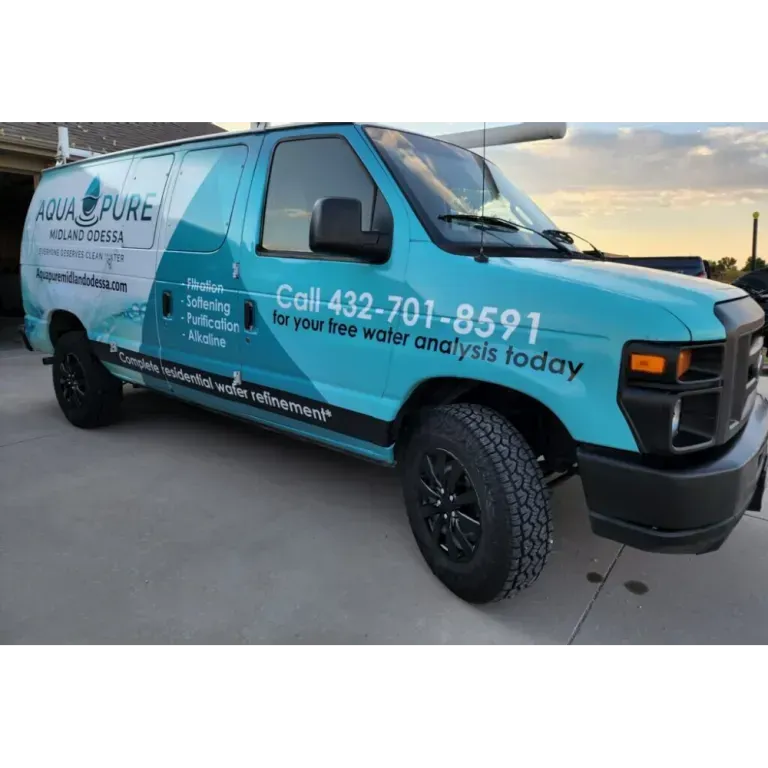 Blue Aqua Pure water treatment van parked outdoors at sunset with company logo and phone number.