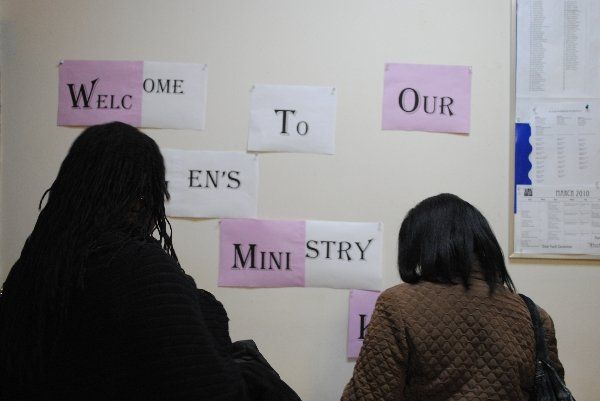 Eastchester Church of God. women are looking at signs on a wall that say welcome to our en 's mini ministry