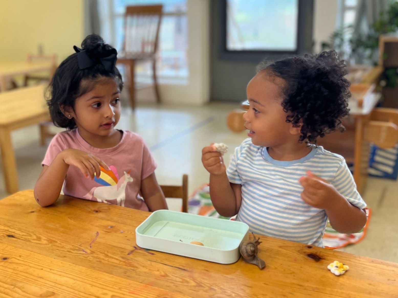 Montessori children sitting at a table