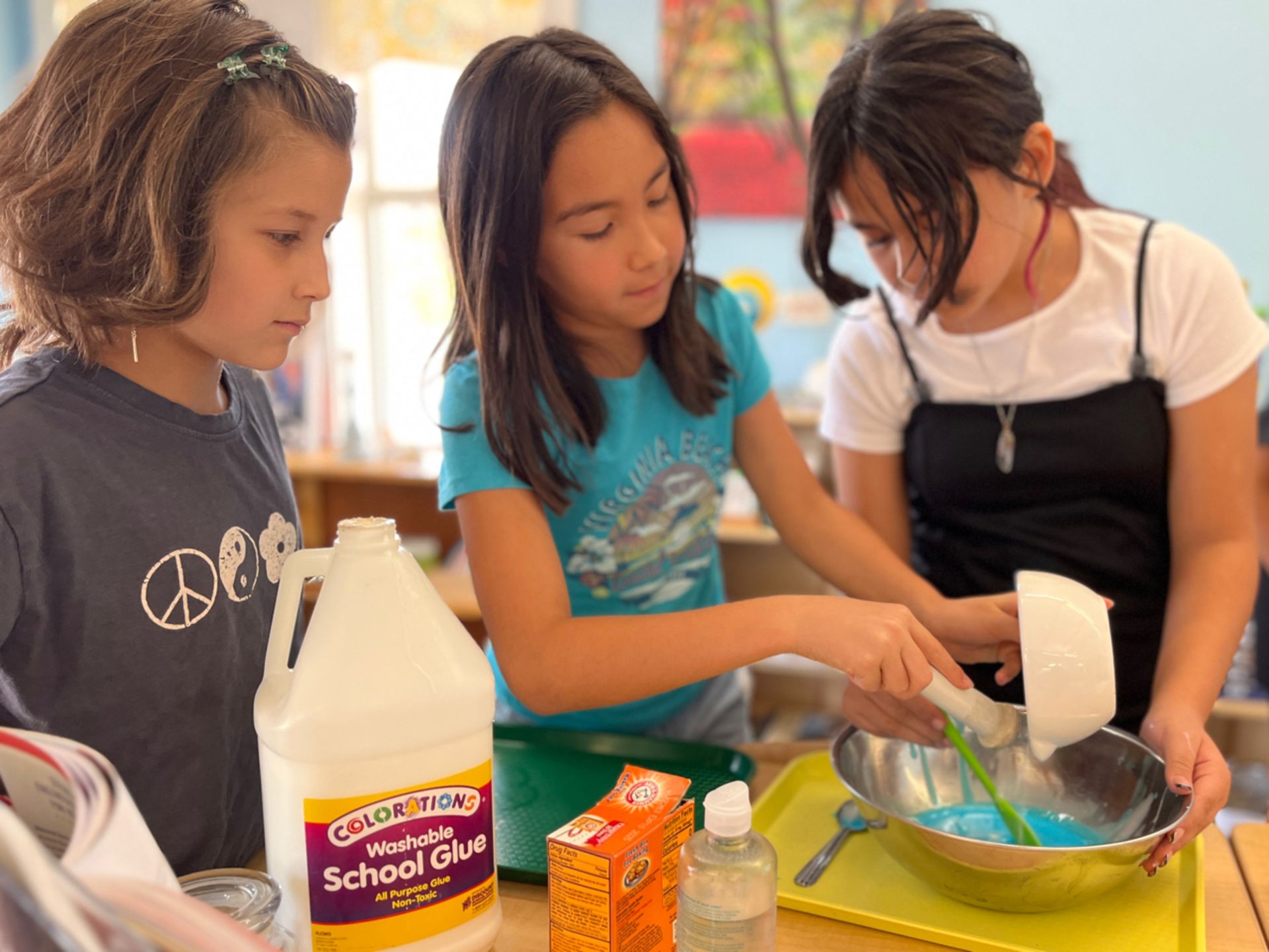 Montessori children working on a bottle of colorations