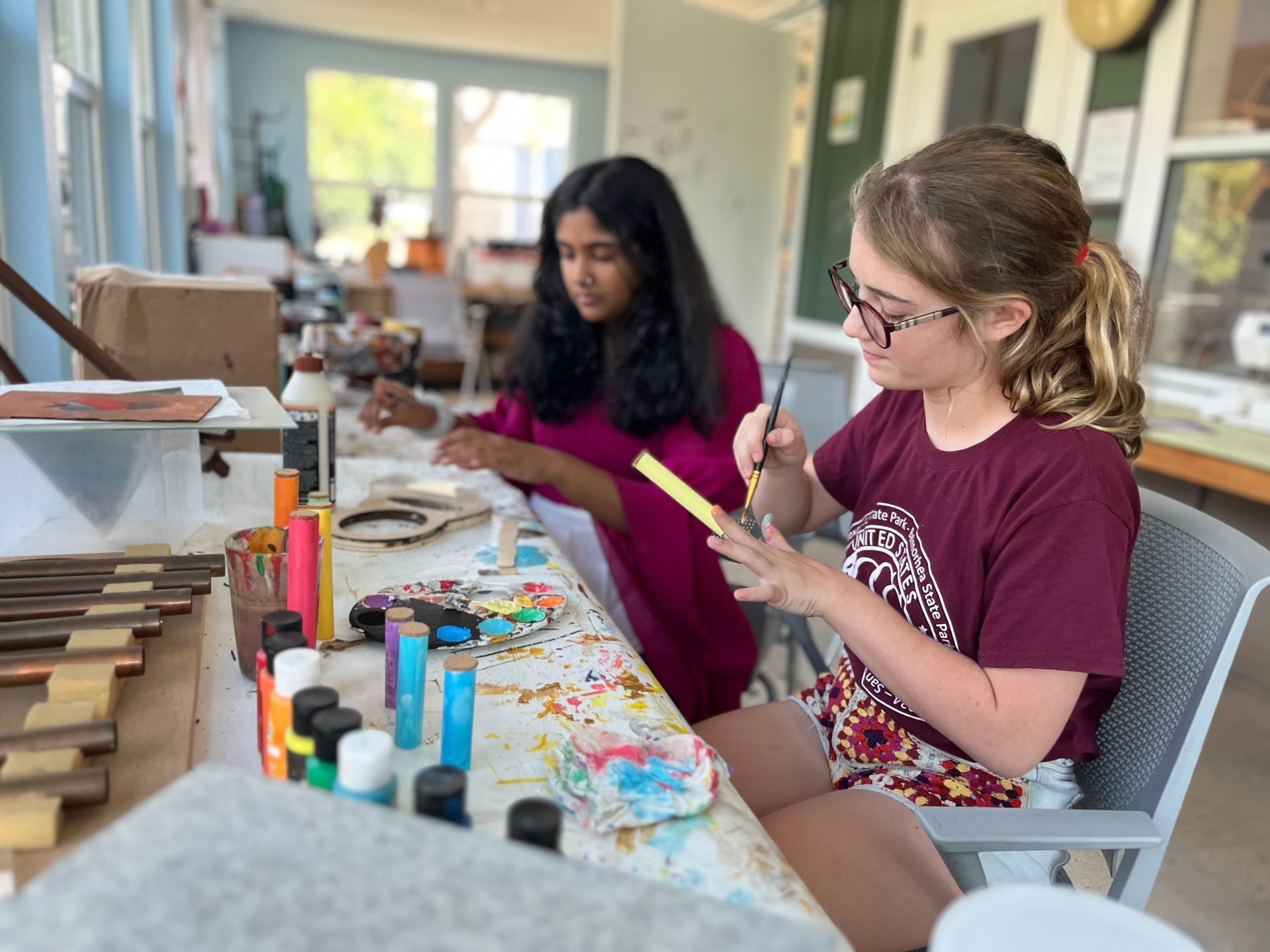 Montessori students working with painting materials