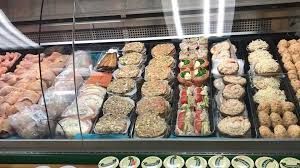 Prepared food display case with various seafood items.