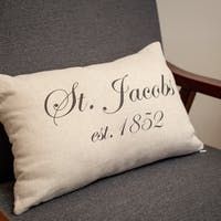 Cream lumbar pillow on a gray chair, featuring