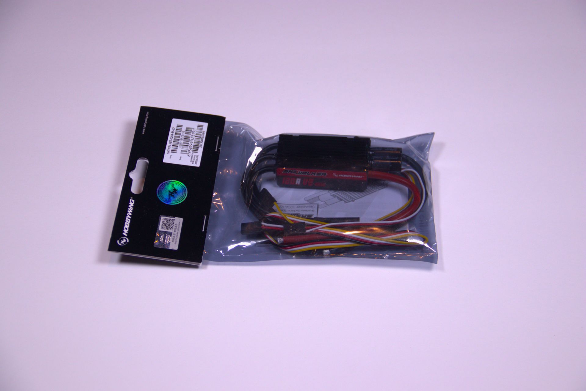Plastic bag of electronic cables with connectors on a white background