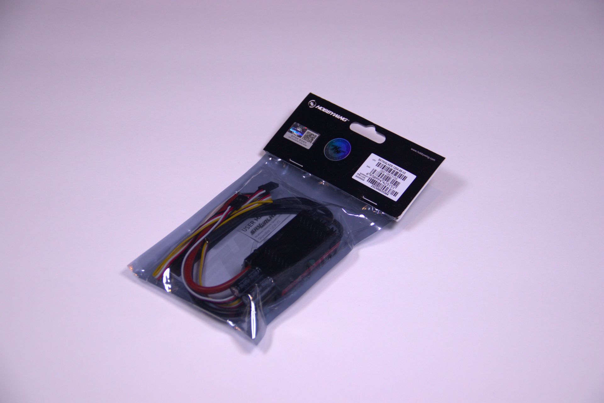 Plastic bag of electronic cables with connectors on a white background