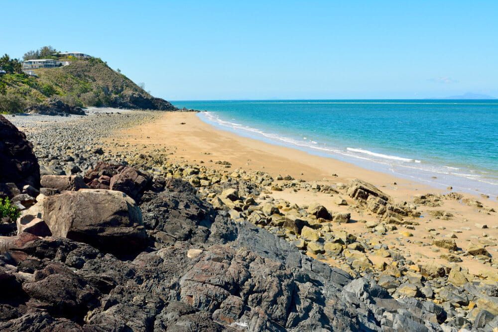 A Rocky Beach With A Large Rock In The Foreground — SureLift Crane Hire In Mackay, QLD