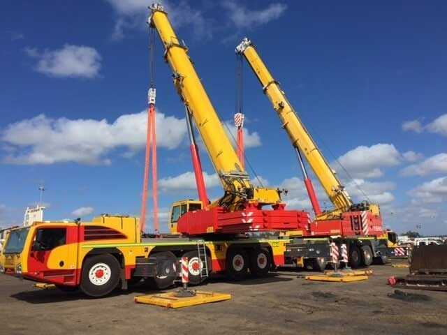 Two Crane Trucks Are Parked Next To Each Other In A Parking Lot — Surelift Crane Hire In Bowen, QLD