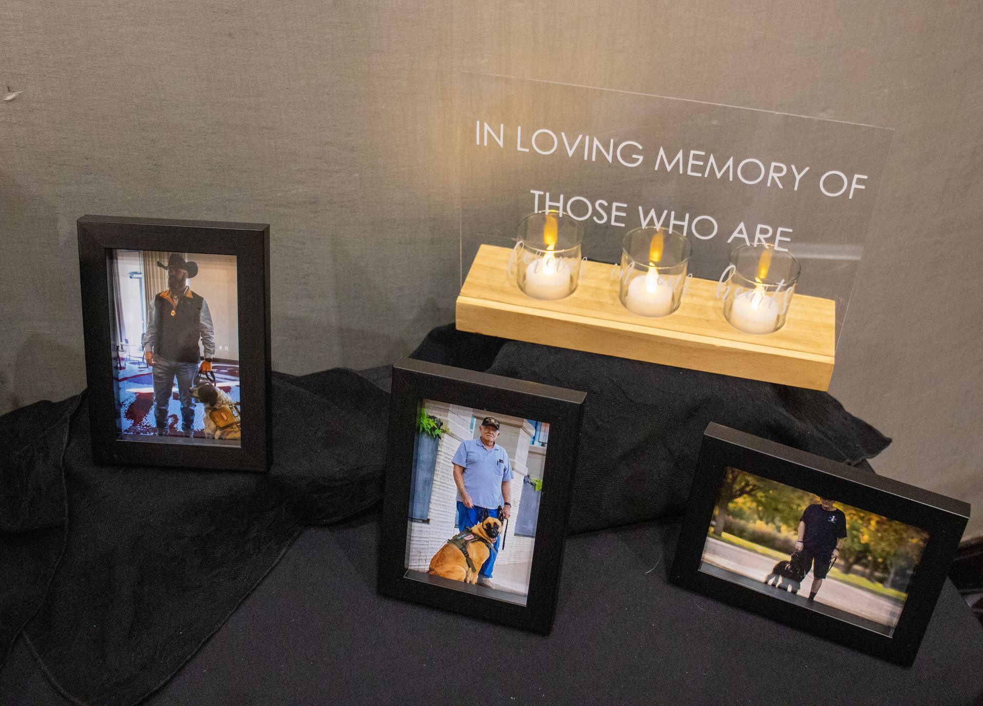 A memorial table with a candle centerpiece and an 