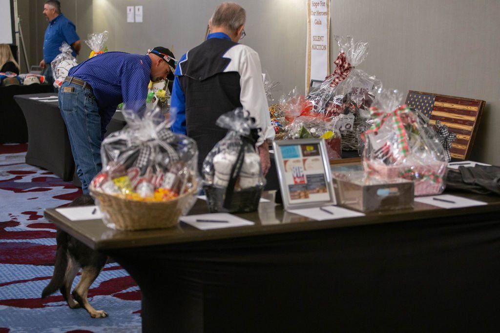 People browse gift baskets at a silent auction event.
