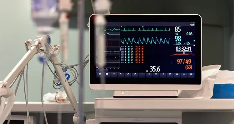 Medical monitor displaying vital signs in a hospital room.