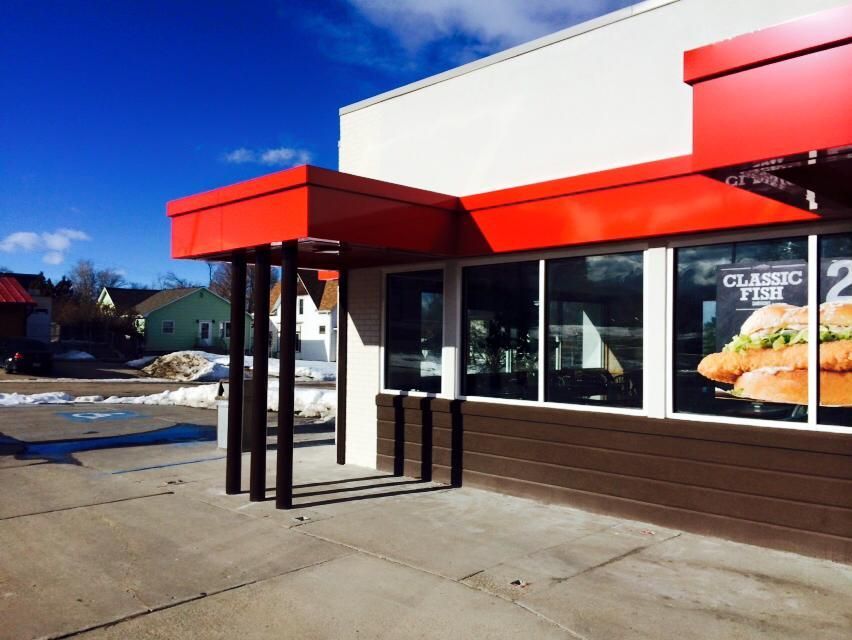 Exterior of a Burger King restaurant with red awning, brown trim, and a 