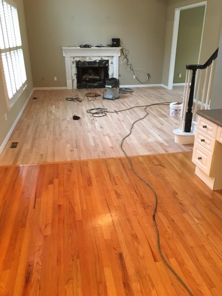 Half-refinished hardwood floor; the top half is sanded, the bottom half is finished and glossy.