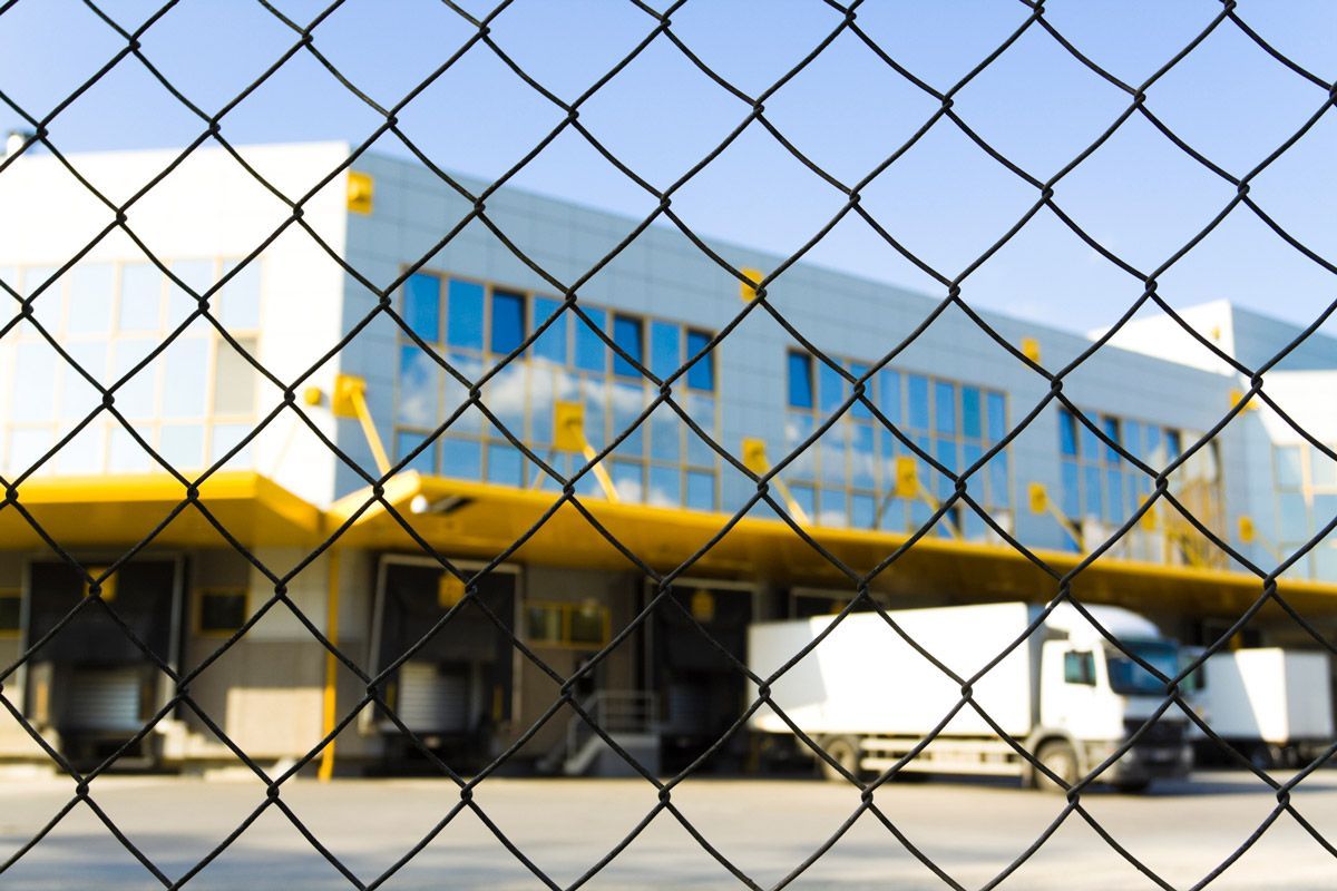 Modern Loading Docks Behind Wired Fence — North Augusta, SC — Aiken Augusta Fence