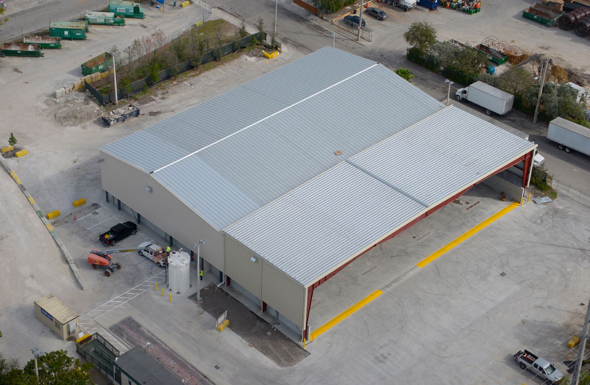 An aerial view of a large warehouse in a parking lot.