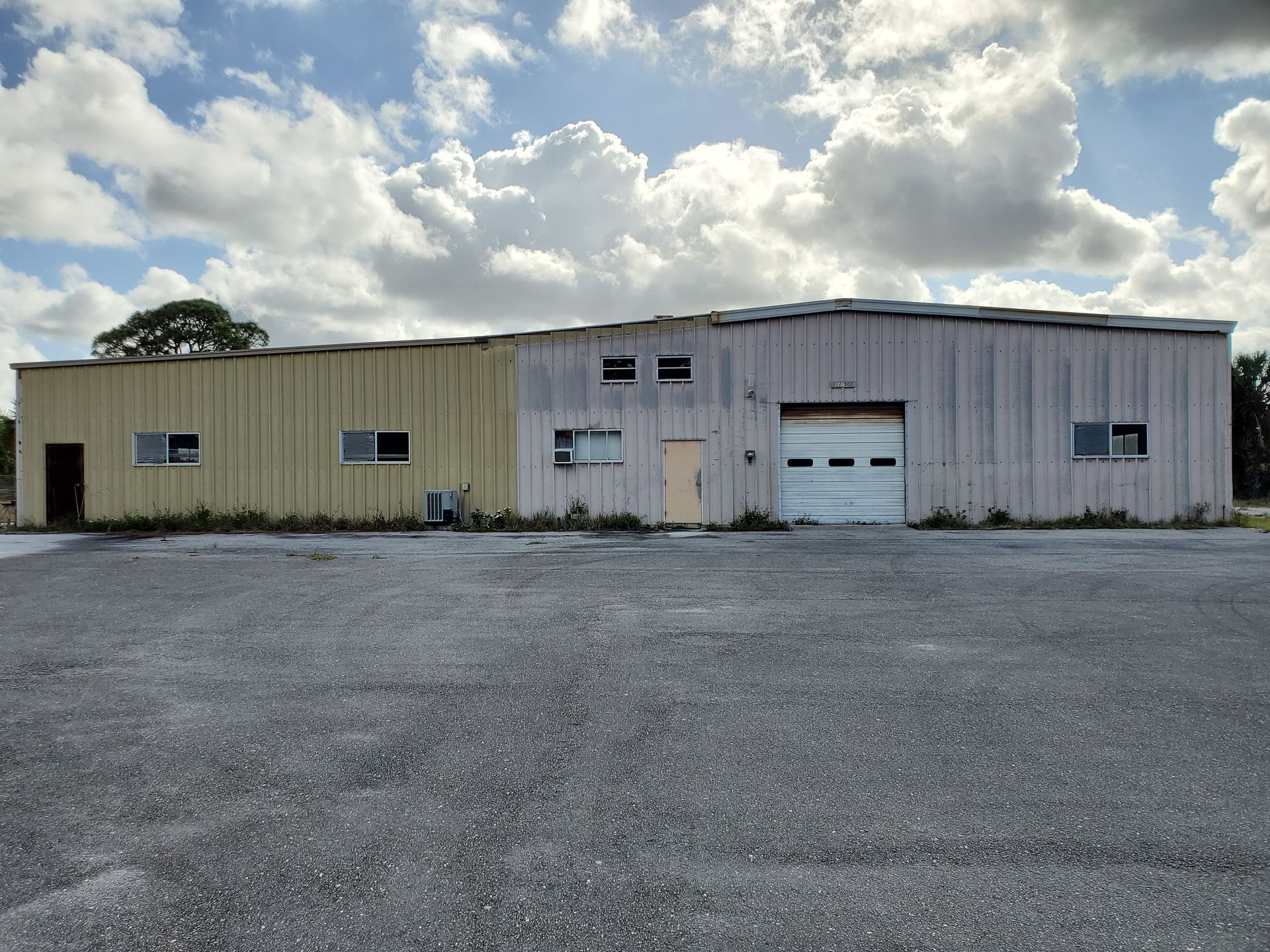 A large building with a garage door and a lot of windows