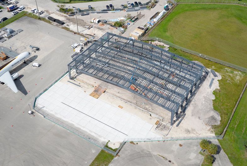 An aerial view of a building under construction in a city.