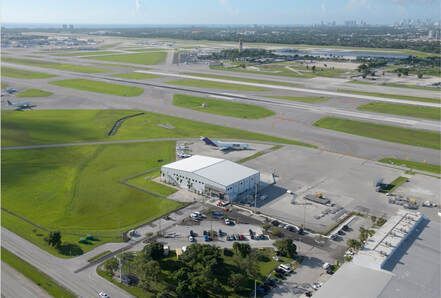 An aerial view of an airport with planes on the runways.