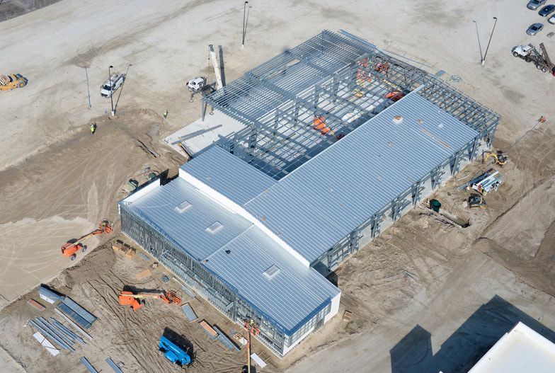 An aerial view of a large building under construction.