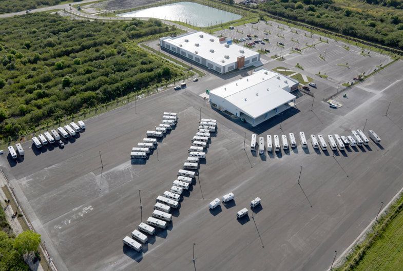 An aerial view of a parking lot with a lot of trucks parked in it.
