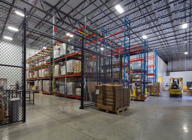 A large warehouse filled with lots of shelves and boxes.