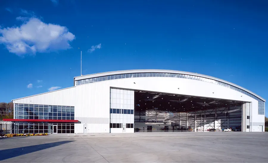 A large white building with a large sliding door.