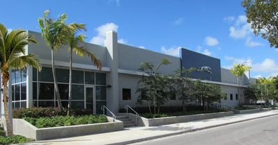 A large building with palm trees in front of it