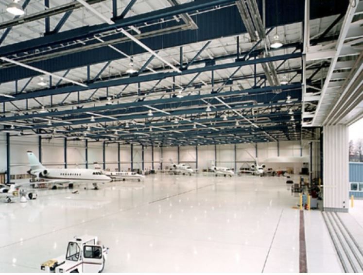 A jet blue airplane is parked in a hangar.