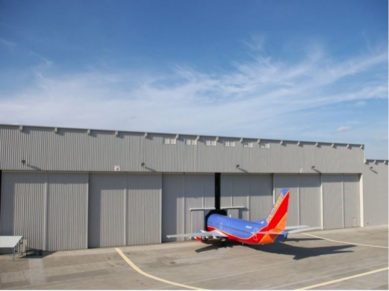 An airplane is parked in a hangar at night