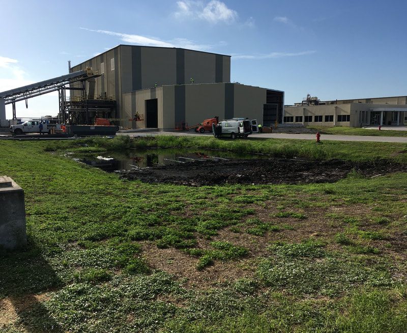A large building with a lot of grass in front of it.