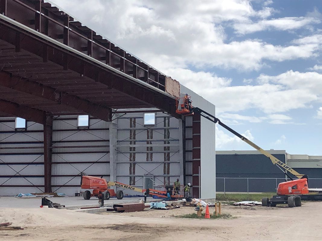 A large building is being built with a crane.