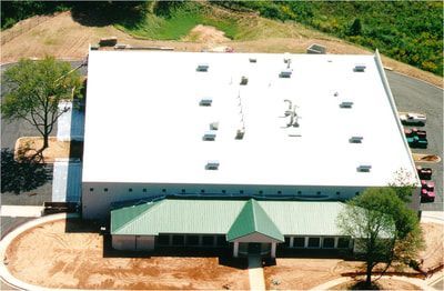 An aerial view of a building with a green roof