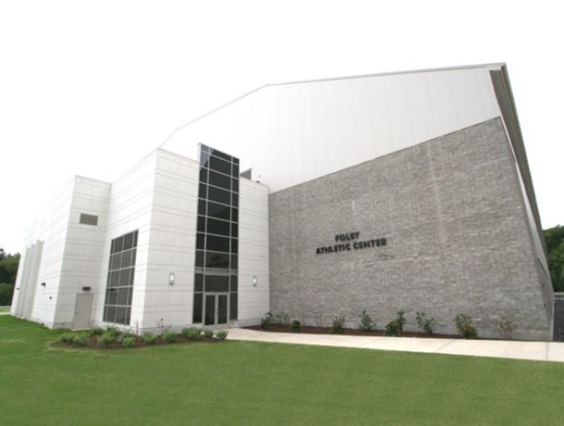 A large white building with the word athletic center on it