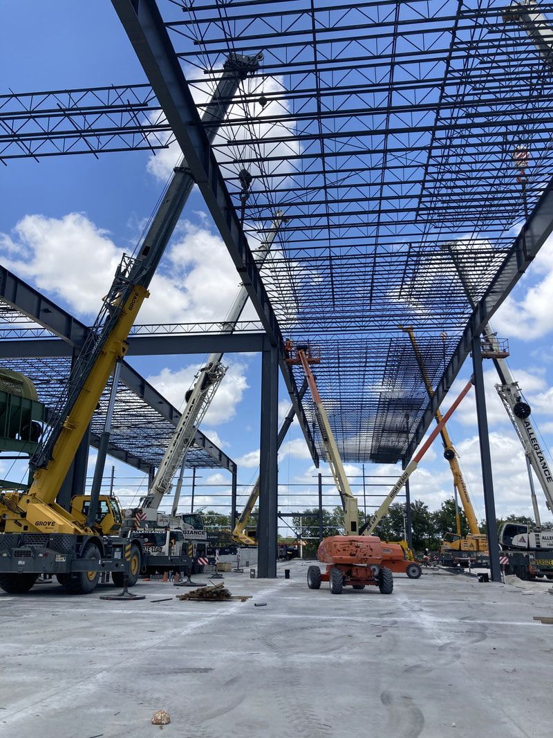 A construction site with a lot of cranes and machinery.