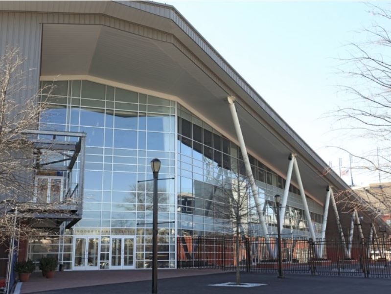 A large building with a lot of windows and trees in front of it