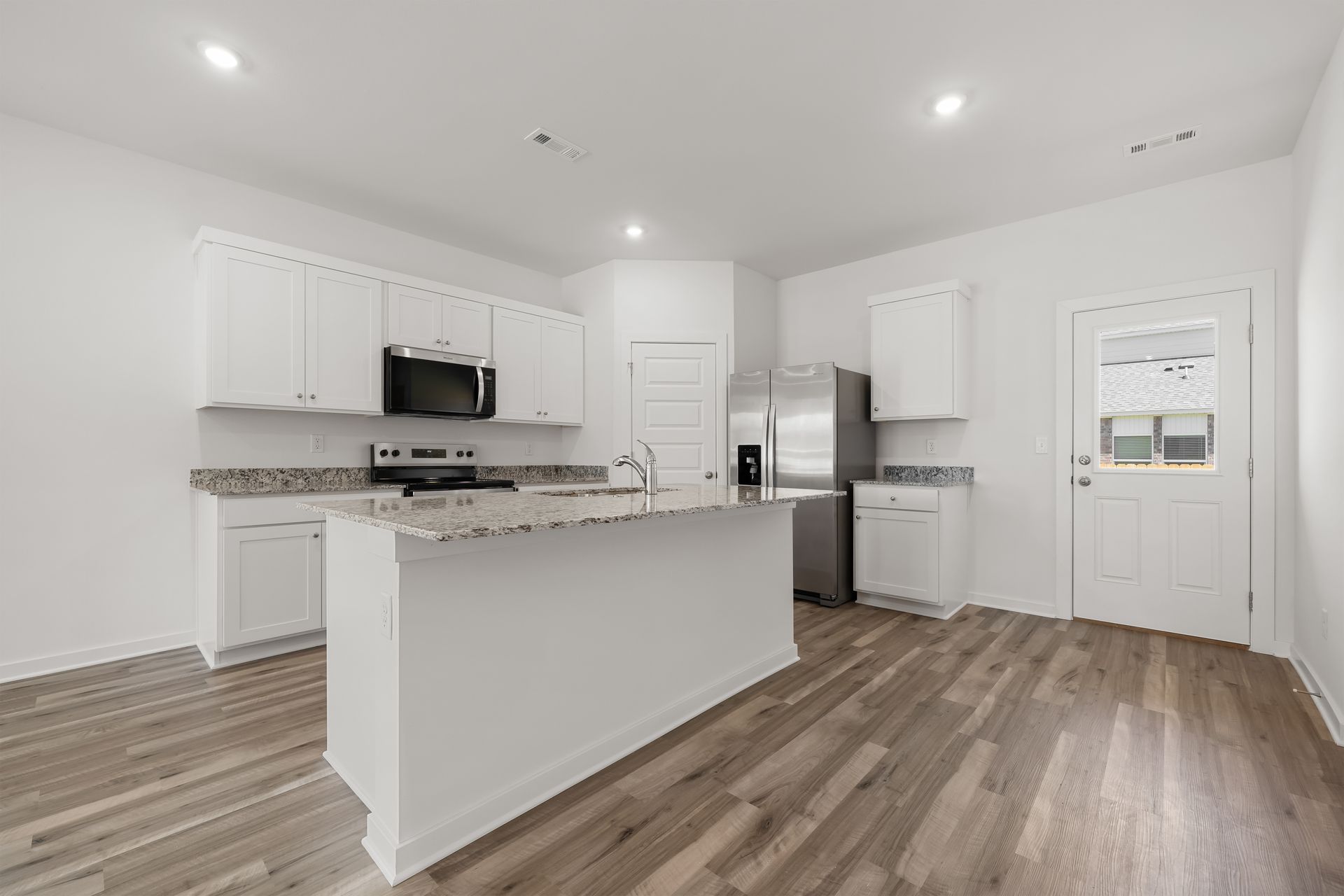 Modern kitchen with large island and stainless steel appliances