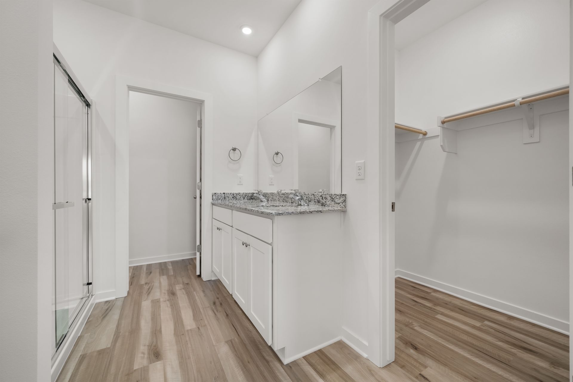 Primary bathroom with dual vanity and modern finishes