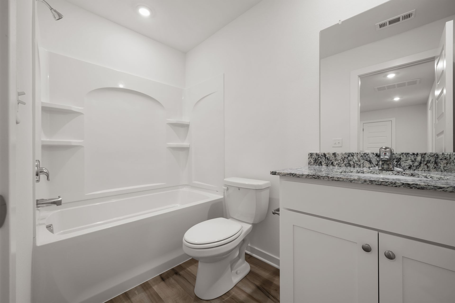 Full upstairs bathroom with vanity and bathtub