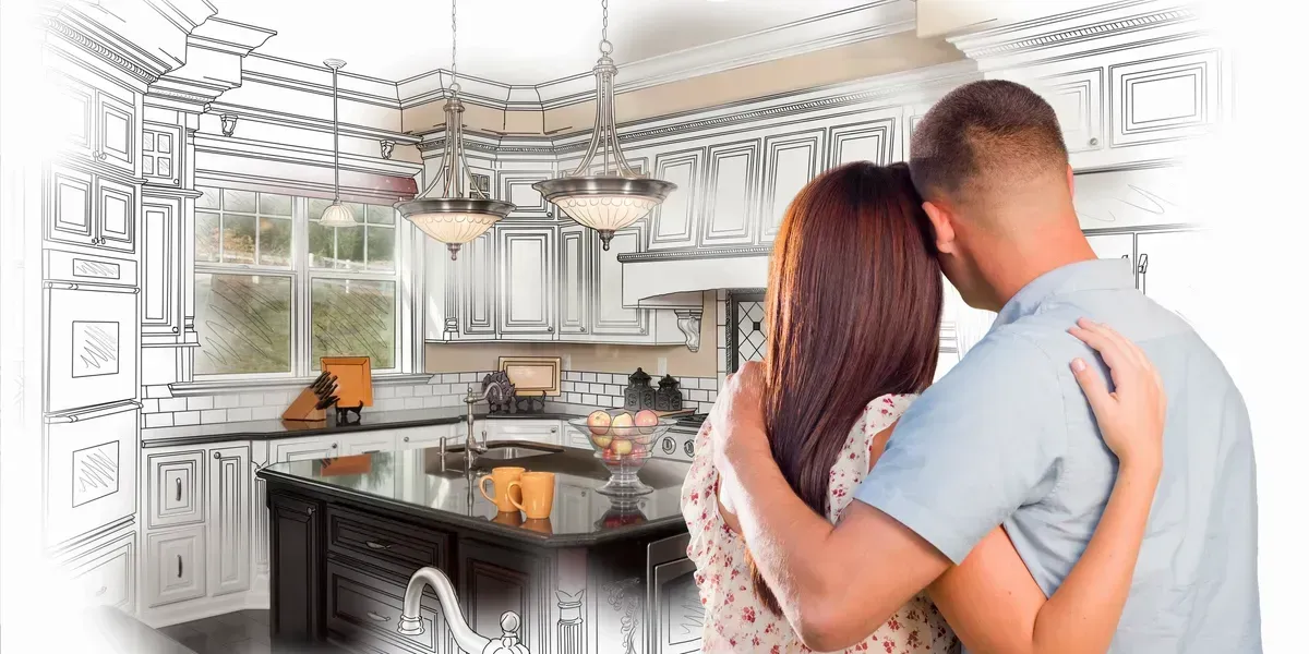 Couple hugging while looking at a kitchen design. The kitchen is partially drawn as a sketch.
