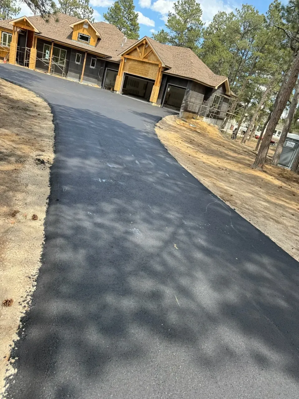 A large house with a driveway leading to it.