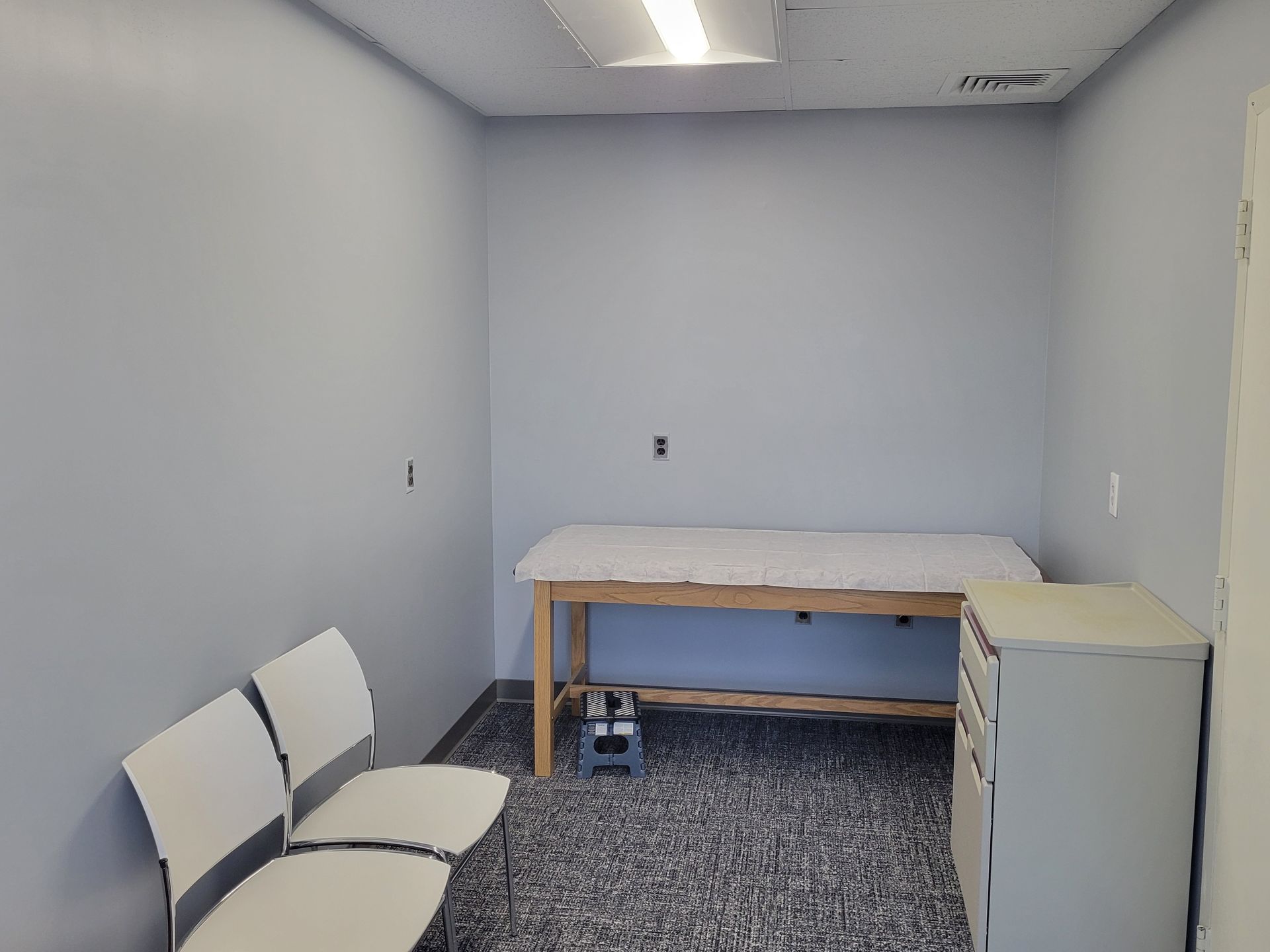 An empty room with a table and chairs in it.