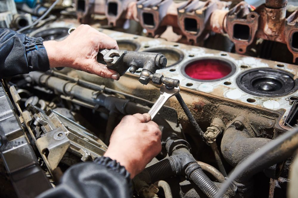 A Person Uses a Wrench to Work on A Industrial Engine in A Workshop — Banana Coast Heavy Diesel in Coffs Harbour, NSW
