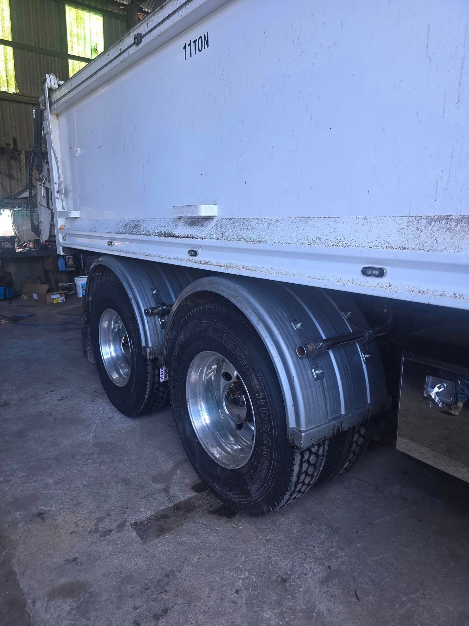 The Rear Wheels and Shiny Silver Fenders of A White Dump Truck — Banana Coast Heavy Diesel in Wells Crossing, NSW
