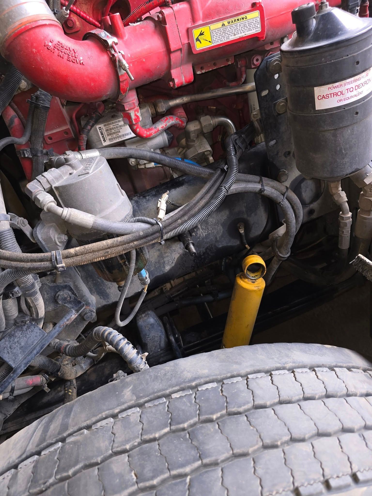 A Heavy Duty Truck Engine Bay Featuring a Bright Yellow Shock Absorber — Banana Coast Heavy Diesel in Wells Crossing, NSW
